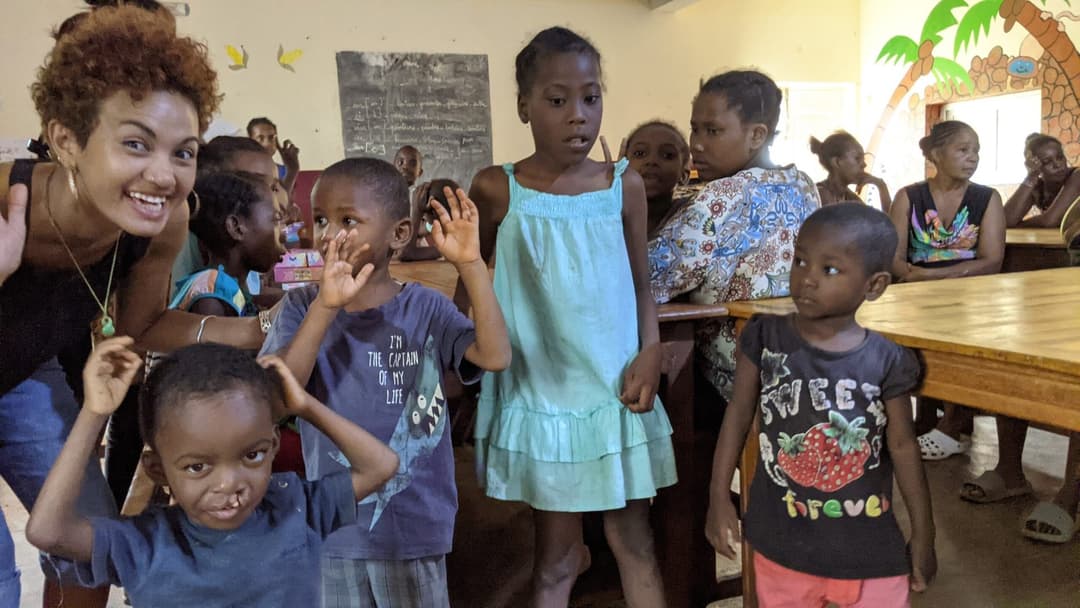 Enfants saluant dans une salle de classe.