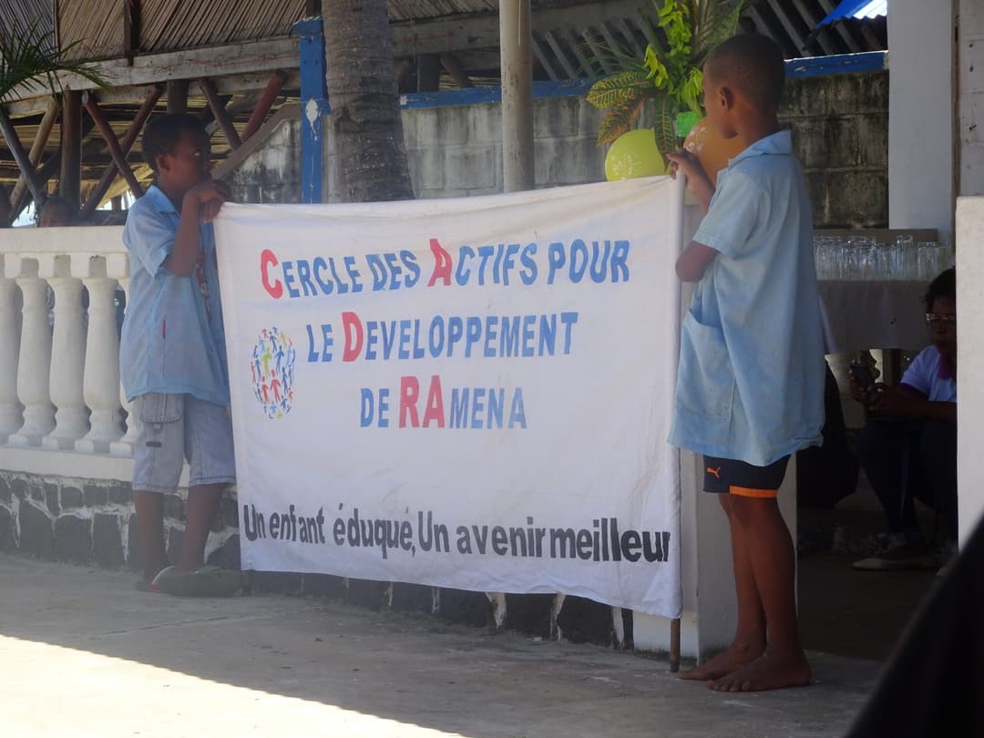Enfants installant la banderole « Un enfant éduqué, un avenir meilleur ».